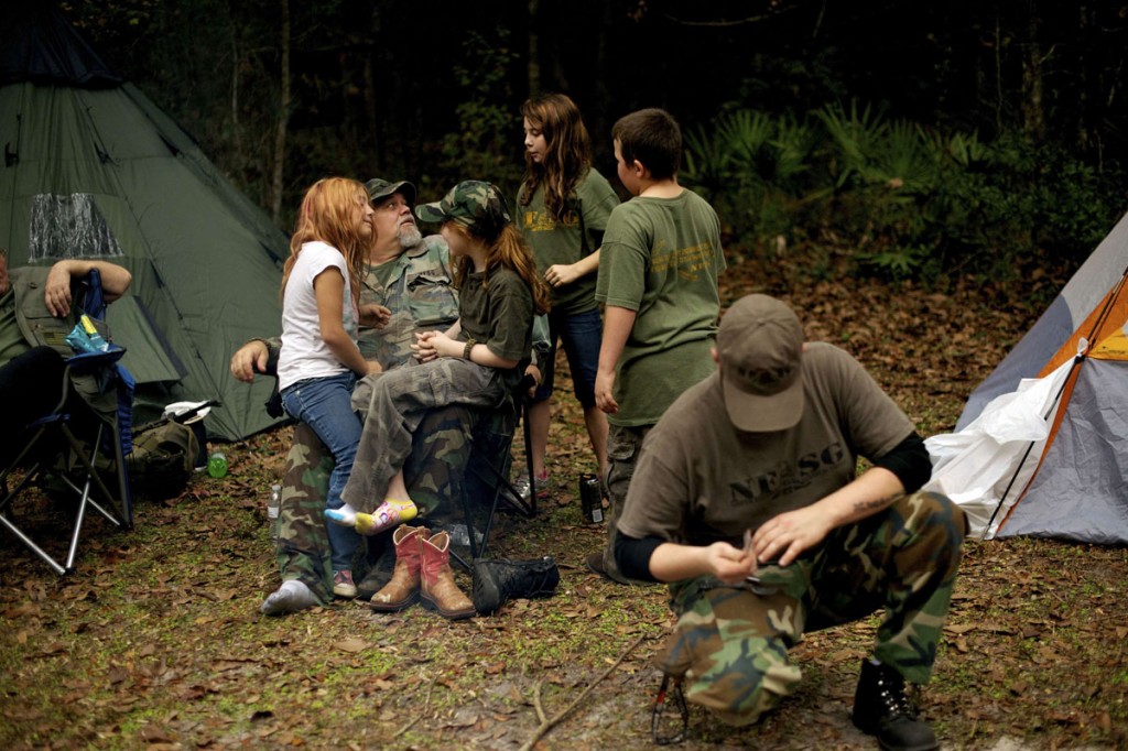 Members of the North Florida Survival Group, including leader Jim Foster (2L) relax in their camp as they take a short break from performing land navigation and enemy contact drills during a field training exercise in Old Town, Florida, December 8, 2012.  The group trains children and adults alike to handle weapons and survive in the wild. The group passionately supports the right of U.S. citizens to bear arms and its website states that it aims to teach "patriots to survive in order to protect and defend our Constitution against all enemy threats". Picture taken December 8, 2013.   REUTERS/Brian Blanco  (UNITED STATES - Tags: SOCIETY POLITICS)    ATTENTION EDITORS: PICTURE 17 OF 20 FOR PACKAGE 'TRAINING CHILD SURVIVALISTS'  SEARCH 'FLORIDA SURVIVAL' FOR ALL IMAGES ORG XMIT: PXP17