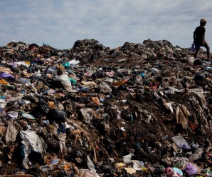 A boy walks through a pile of garbage and human waste in Old Fadama slum, Accra, Ghana, October 24, 2010.