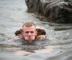 The Wisconsin Army National Guard's 1st Lt. Nicholas Plocar tows a poncho raft filled with military gear as part of a demanding water obstacle April 14, during the 2013 Best Ranger Competition at Fort Benning, Ga. (MCoE photo by Patrick Albright)